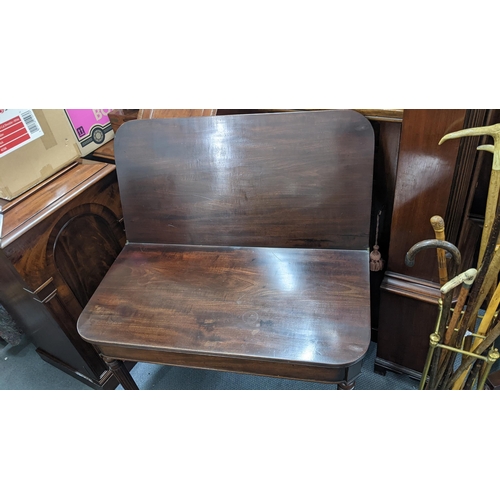 499 - An early 19th century Gillows style mahogany fold over tea table on four fluted tapering legs, 73cm ... 