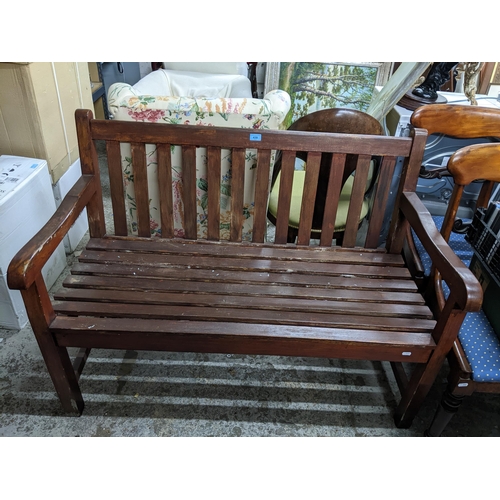 439 - A stained wooden slatted two-seater garden bench 89cm x 121cm x 60cm Location: G
If there is no cond... 