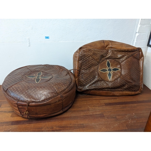 462 - Two pouffes, one circular and one square in brown leather, each decorated with a central flower
Loca... 