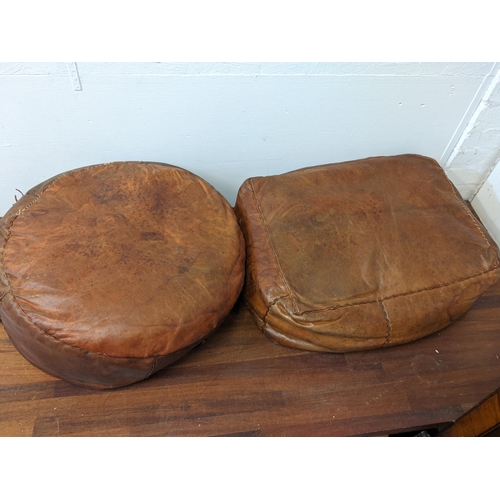 462 - Two pouffes, one circular and one square in brown leather, each decorated with a central flower
Loca... 