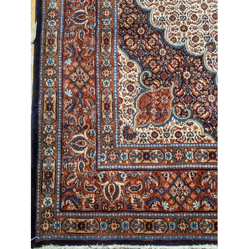 513 - A Persian Tabriz handwoven rug, allover floral pattern on a cream and blue ground, triple guard bord... 