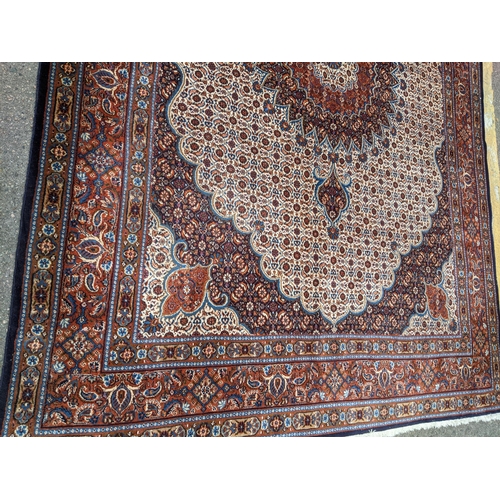 513 - A Persian Tabriz handwoven rug, allover floral pattern on a cream and blue ground, triple guard bord... 