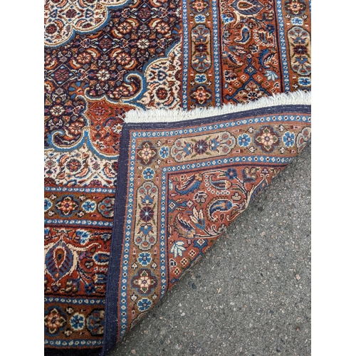 513 - A Persian Tabriz handwoven rug, allover floral pattern on a cream and blue ground, triple guard bord... 