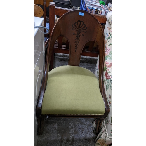 516 - A Victorian mahogany spoon back chair with inlaid floral decoration, upholstered seat on front forwa... 