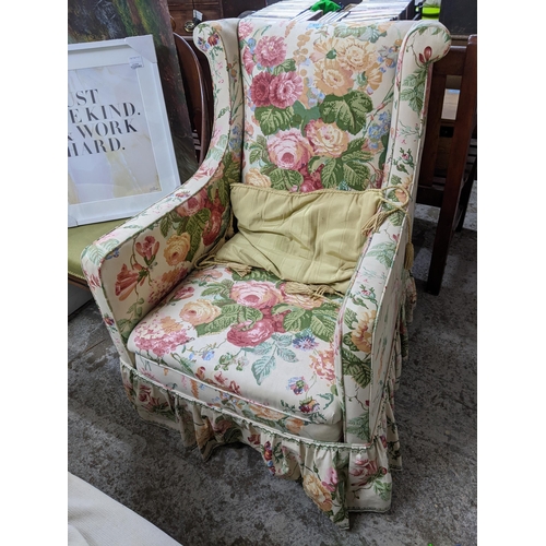 517 - A late Victorian upholstered armchair, floral fabric with loose, turned front legs, ceramic casters
... 