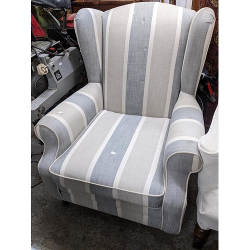 520 - A modern Uniquemade Ltd upholstered wing back armchair on turned front legs and castors Location: G
... 