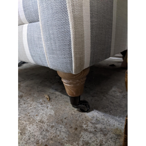 520 - A modern Uniquemade Ltd upholstered wing back armchair on turned front legs and castors Location: G
... 