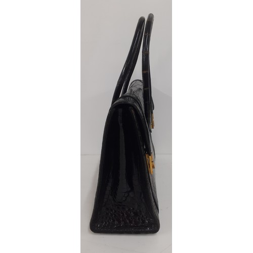 1 - Hermes- A 1970's black porosus crocodile 'Drag 26' handbag 26cm wide x 20cm high having gold tone ha... 