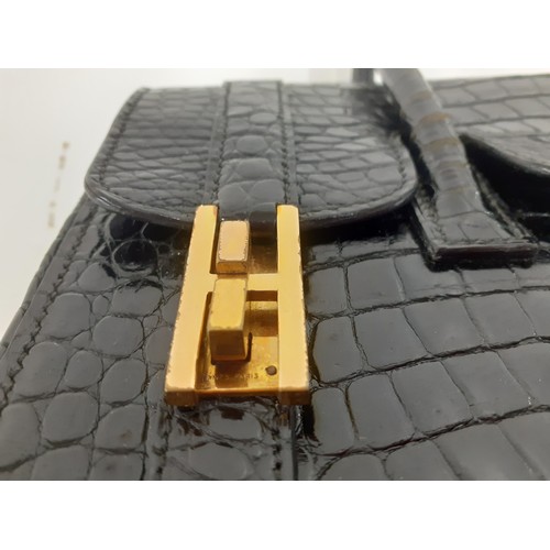 1 - Hermes- A 1970's black porosus crocodile 'Drag 26' handbag 26cm wide x 20cm high having gold tone ha... 