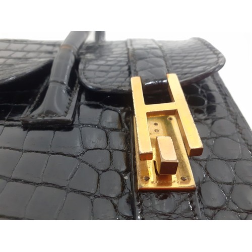 1 - Hermes- A 1970's black porosus crocodile 'Drag 26' handbag 26cm wide x 20cm high having gold tone ha... 