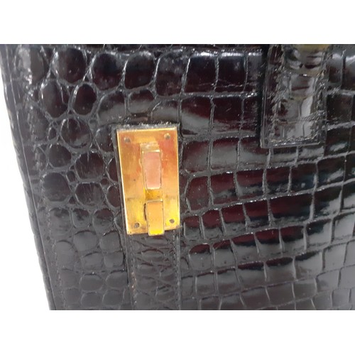 1 - Hermes- A 1970's black porosus crocodile 'Drag 26' handbag 26cm wide x 20cm high having gold tone ha... 