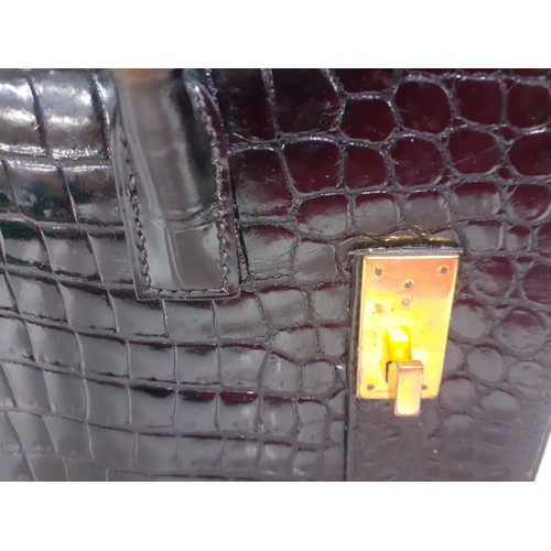 1 - Hermes- A 1970's black porosus crocodile 'Drag 26' handbag 26cm wide x 20cm high having gold tone ha... 