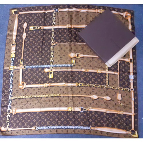 2 - Louis Vuitton- A brown LV monogram silk scarf with belt and chain design having hand rolled edges to... 