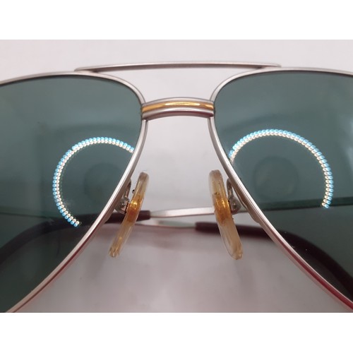 14 - Cartier- A pair of large aviator style sunglasses having green tinged lenses and 2 tone hardware, si... 