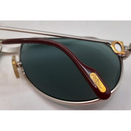 14 - Cartier- A pair of large aviator style sunglasses having green tinged lenses and 2 tone hardware, si... 