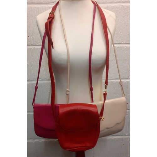 16 - Paloma Picasso and Bruno Magli-An unused red leather crossover/shoulder bag having gold tone hardwar... 