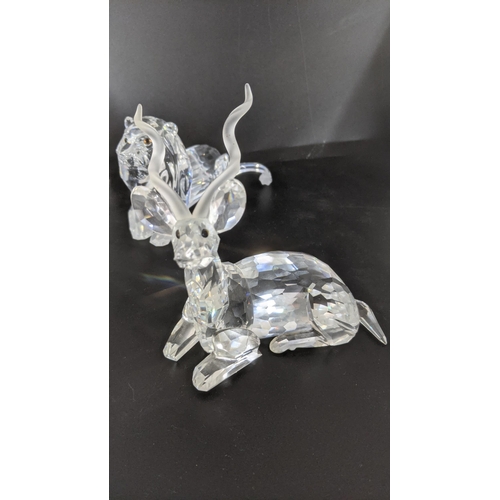 442 - ***THIS LOT HAS BEEN WITHDRAWN***Four boxed Swarovski Crystal examples to include a pair of Lions, a... 