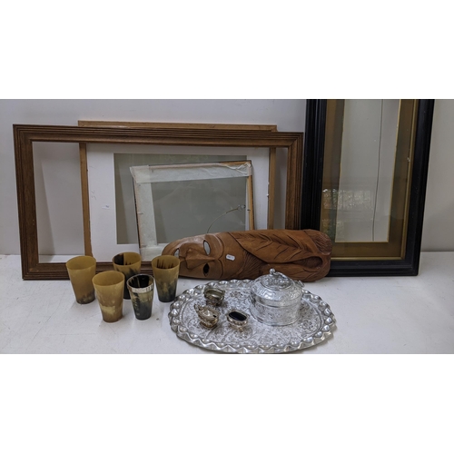 497 - A mixed lot to include an Indian silver plated Paan box and tray, horn cups, frames, tribal mask, si... 