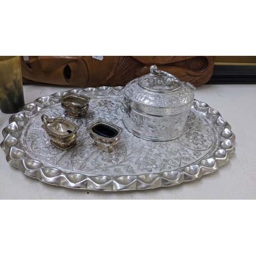 497 - A mixed lot to include an Indian silver plated Paan box and tray, horn cups, frames, tribal mask, si... 