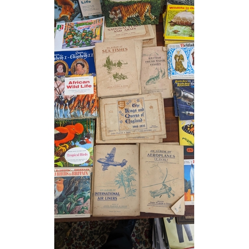 455 - A collection of collectors cards in books and various cigarette cards to include National Flags & Ar... 