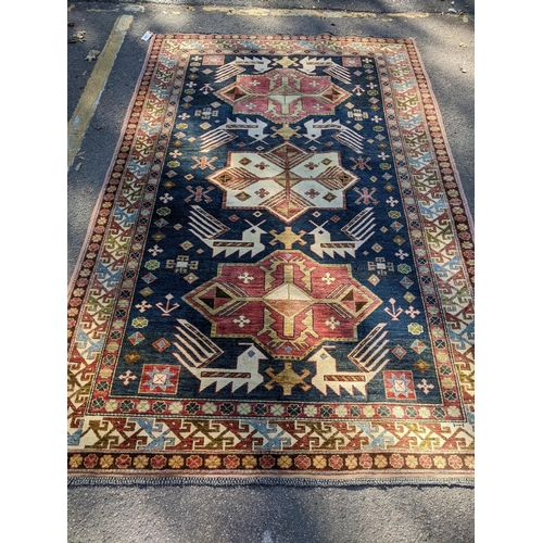 469 - An Afghan Kazak rug, handwoven, geometric designs on a blue ground, multiguard borders, tasselled en... 