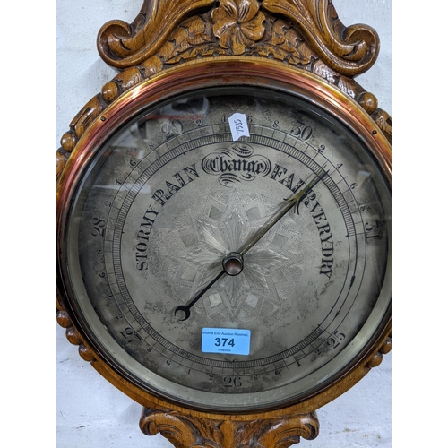 480 - A Victorian carved oak wheel barometer, silvered dial with engraved decoration to the centre, below ... 