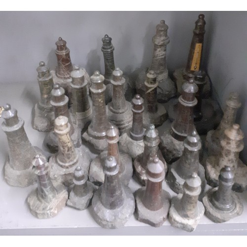 465 - A large group of Cornish carved serpentine stone lighthouse models, the largest measuring 18cm and t... 