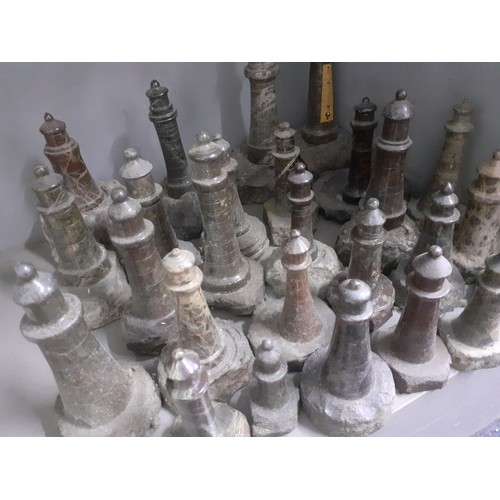 465 - A large group of Cornish carved serpentine stone lighthouse models, the largest measuring 18cm and t... 