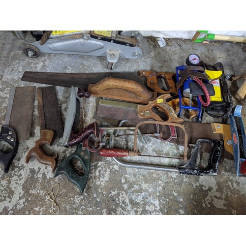 492 - A mixed lot of tools and gardening tools including a trolley jack, hobby fretsaw, spades, vintage sa... 