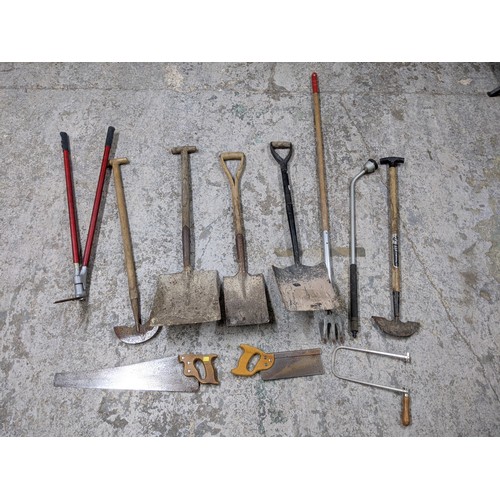 492 - A mixed lot of tools and gardening tools including a trolley jack, hobby fretsaw, spades, vintage sa... 