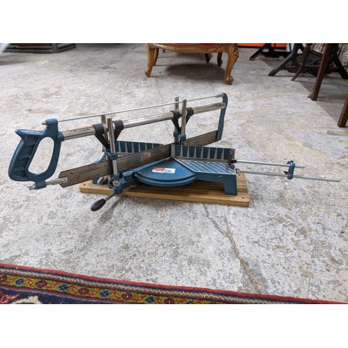 492 - A mixed lot of tools and gardening tools including a trolley jack, hobby fretsaw, spades, vintage sa... 