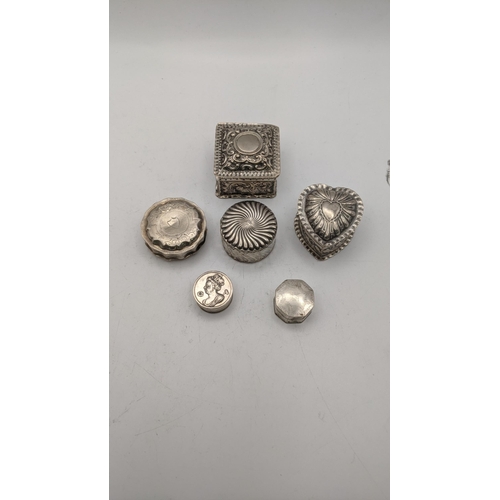 111 - A collection of silver trinket boxes to include a heart shaped example having embossed details and o... 