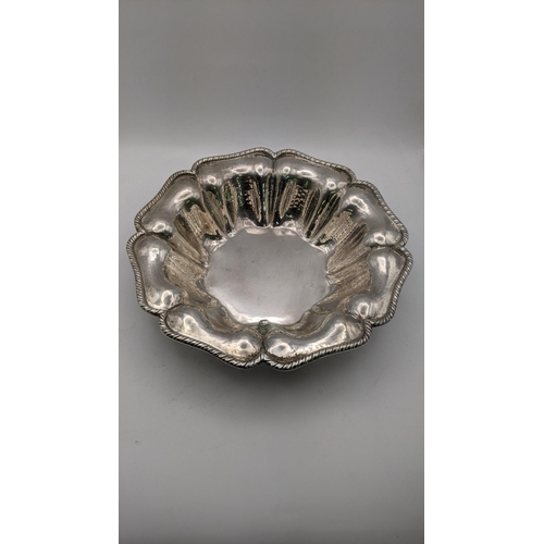 123 - A silver bowl stamped 800 having a gadrooned shaped rim and hammered decoration 239.7g
Location: R2-... 