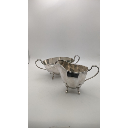 124 - Silver to include a sugar bowl and cream jug on four feet hallmarked Birmingham 1938, total weight 4... 