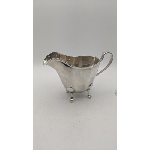 124 - Silver to include a sugar bowl and cream jug on four feet hallmarked Birmingham 1938, total weight 4... 