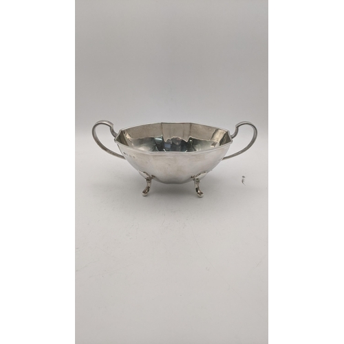 124 - Silver to include a sugar bowl and cream jug on four feet hallmarked Birmingham 1938, total weight 4... 