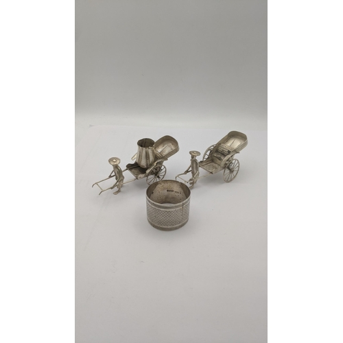 128 - A pair of white metal condiments A/F stamp 90 94.7g together with a silver napkin ring 34.4g
Locatio... 