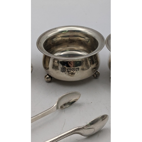 131 - Silver to include condiment pots, sugar tongs, a napkin ring and silver handled button hook, total w... 