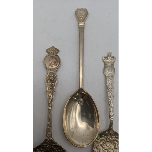 145 - A group of silver commemorative spoons to include two floral embossed examples and one other, togeth... 