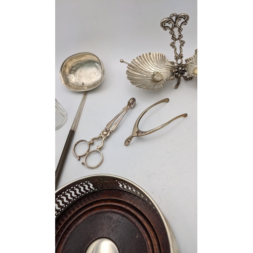 149 - Silver to include a wine coaster, sugar nips, wishbone tongs, a white metal twin bon bon dish, toget... 