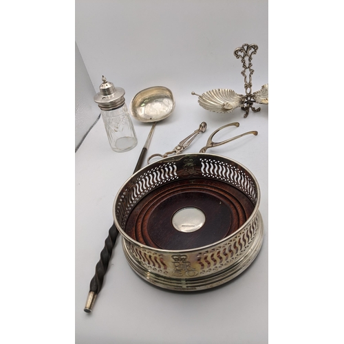 149 - Silver to include a wine coaster, sugar nips, wishbone tongs, a white metal twin bon bon dish, toget... 