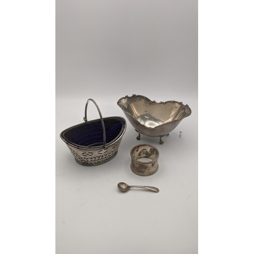 153 - Silver to include a pierced sugar basket with a blue glass liner, together with a sterling silver su... 