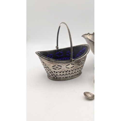 153 - Silver to include a pierced sugar basket with a blue glass liner, together with a sterling silver su... 