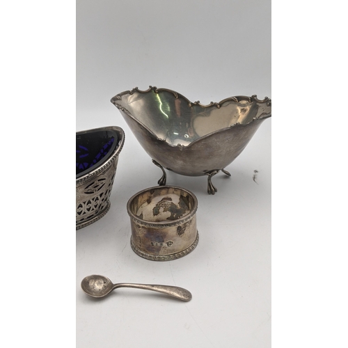 153 - Silver to include a pierced sugar basket with a blue glass liner, together with a sterling silver su... 