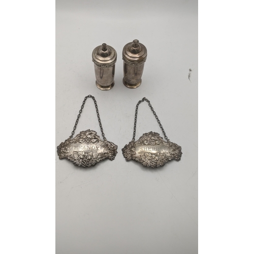 158 - A pair of silver salt and pepper and two decanter labels sherry and brandy, total weight 102.2g
Loca... 