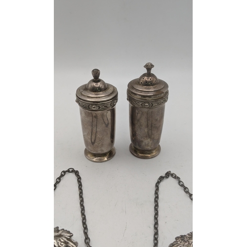 158 - A pair of silver salt and pepper and two decanter labels sherry and brandy, total weight 102.2g
Loca... 