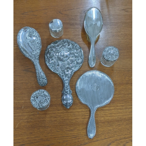 163 - Silver dressing table items to include two hand mirrors, three dressing table jars and two brushes
L... 