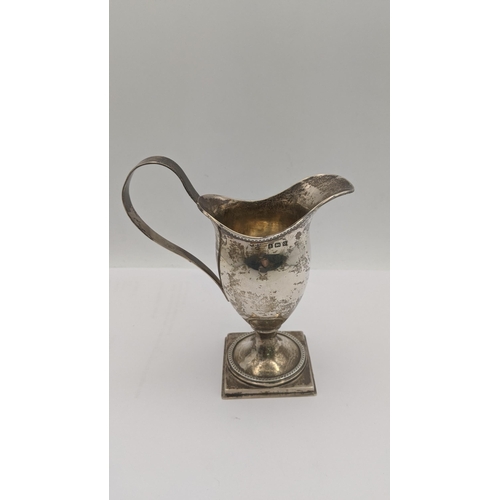 17 - A silver cream jug and two napkin rings 150.8g Location: A3M
If there is no condition report shown, ... 