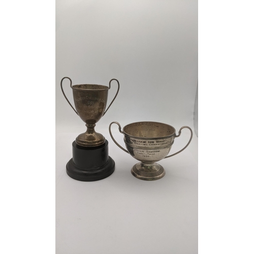 63 - Two silver trophy cups to include one example entitled to Birmingham ice rink 1933, 112.4g together ... 