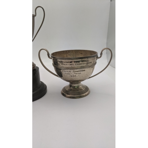 63 - Two silver trophy cups to include one example entitled to Birmingham ice rink 1933, 112.4g together ... 